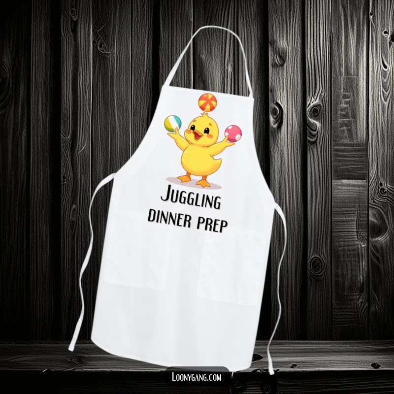 Funny yellow duckling apron designed with a happy duckling juggling balls, perfect for kitchen fun and a humorous cooking experience. A great gift.