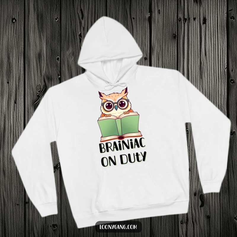 Funny hoodie showing a cute owl wearing crooked glasses, peeking over a giant book, ideal for cozy reading sessions.