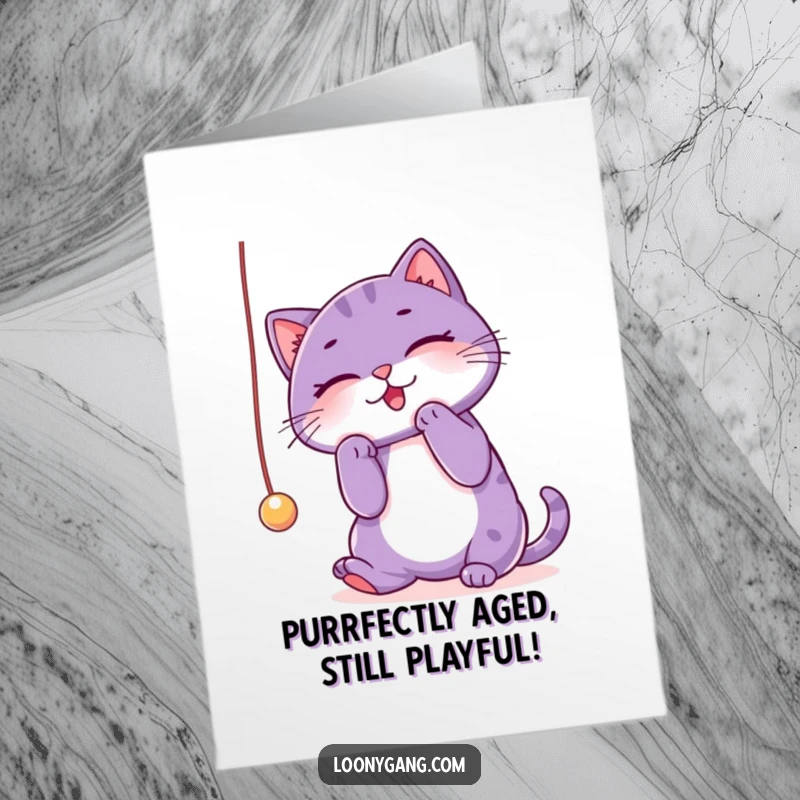 Funny Free Printable Birthday Card: Purple cat batting playfully at a string, ready for a laugh.