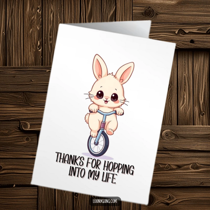 Funny Free Printable Thank You card of a fluffy rabbit with wide eyes skillfully balancing on a unicycle.