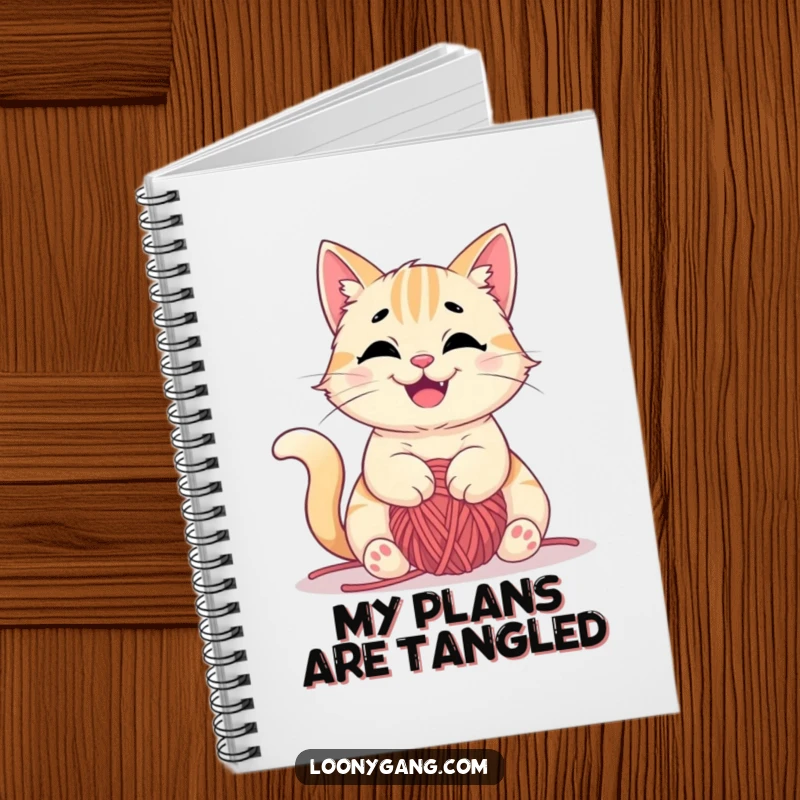 Funny notebook with a mischievous cat happily tangled in yarn on the cover, ideal for notes and projects, great funny gift.