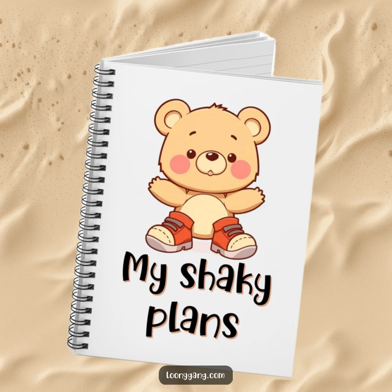 A lined notebook featuring a cover illustration of a funny bear cub wearing oversized shoes and wobbling adorably.